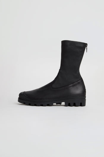 Stitch Detail Napa Leather Stretch Boots in black, featuring a mid-calf silhouette, chunky tread sole, and side zipper; crafted from nappa leather and handmade in Italy, showcased against a plain white background.