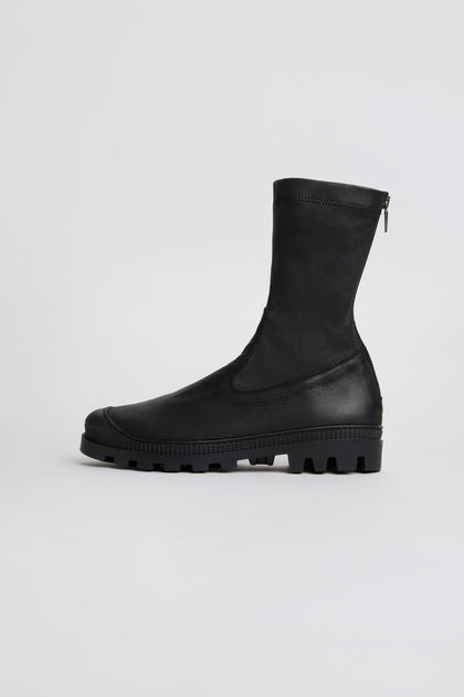 Stitch Detail Napa Leather Stretch Boots in black, featuring a mid-calf silhouette, chunky tread sole, and side zipper; crafted from nappa leather and handmade in Italy, showcased against a plain white background.