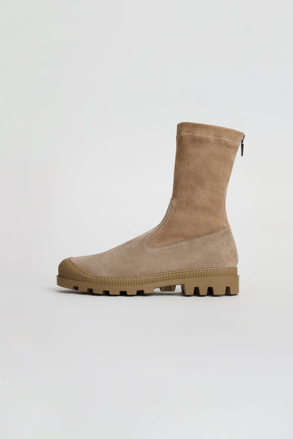 The Stitch Detail Suede Stretch Boots are tan suede mid-calf boots featuring a chunky rubber sole, side zipper, and rounded toe, expertly handmade in Italy and displayed on a plain white background.