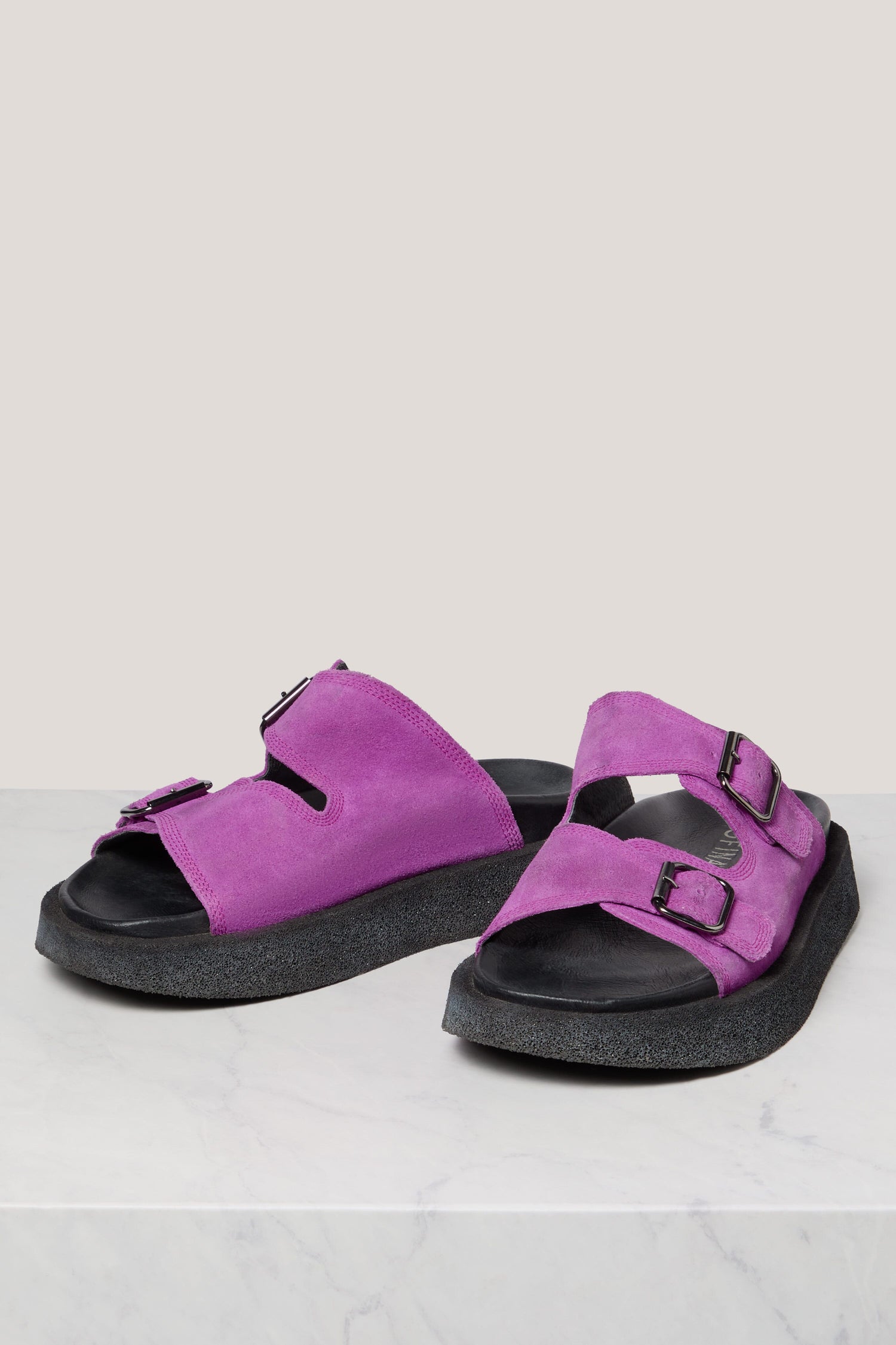 A pair of purple Suede Double Buckle Slider sandals displayed on a white surface.