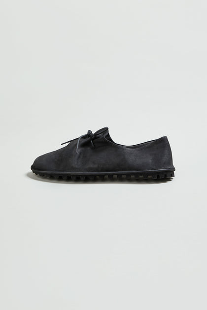The Crushed Leather Lace Up Shoe is displayed on a plain light background, featuring black handmade Italian craftsmanship and a textured rubber sole.