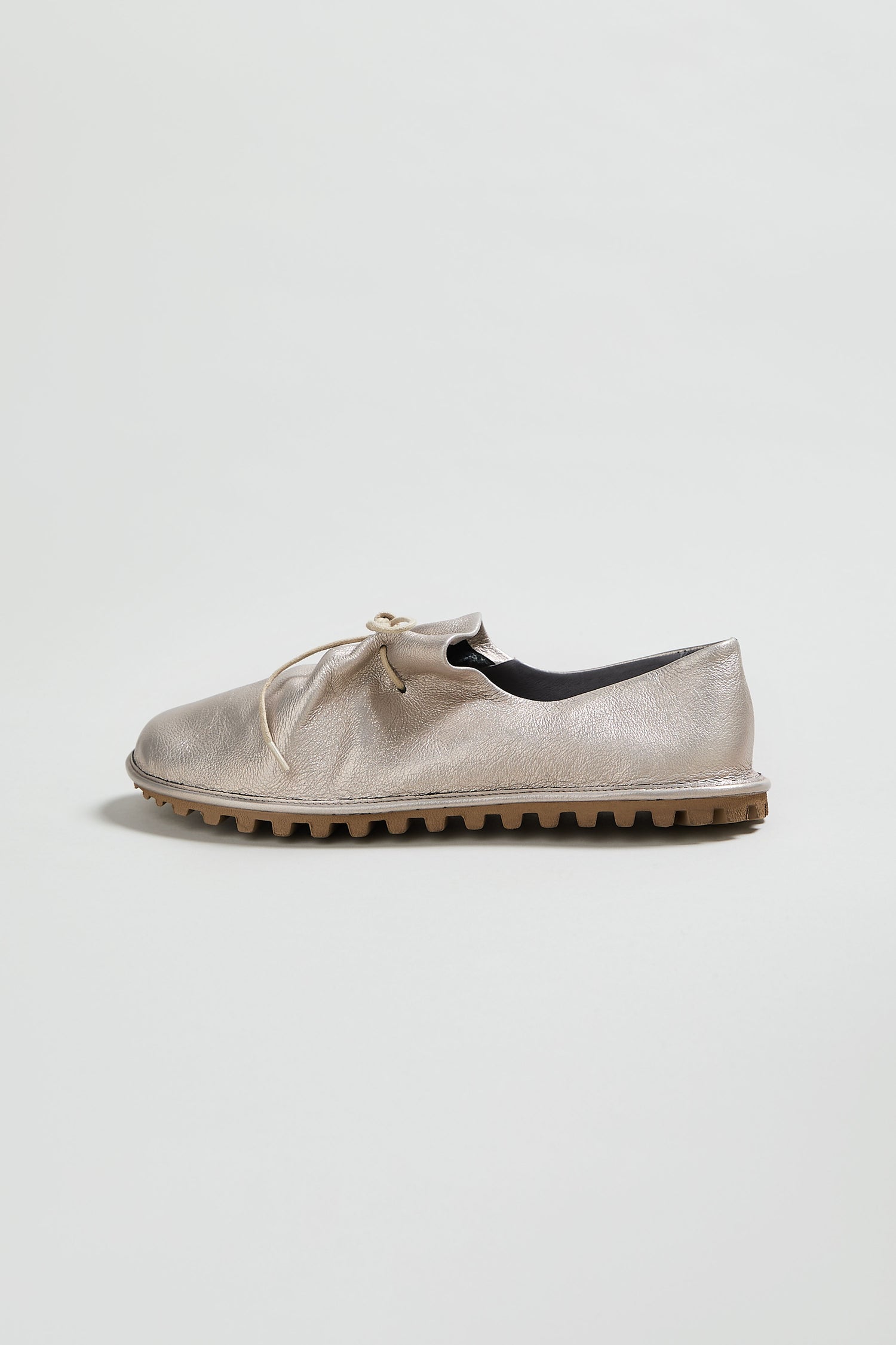 A single Crushed Leather Lace up Shoe in metallic silver, handmade in Italy from crushed leather with a textured sole, displayed on a plain white background.