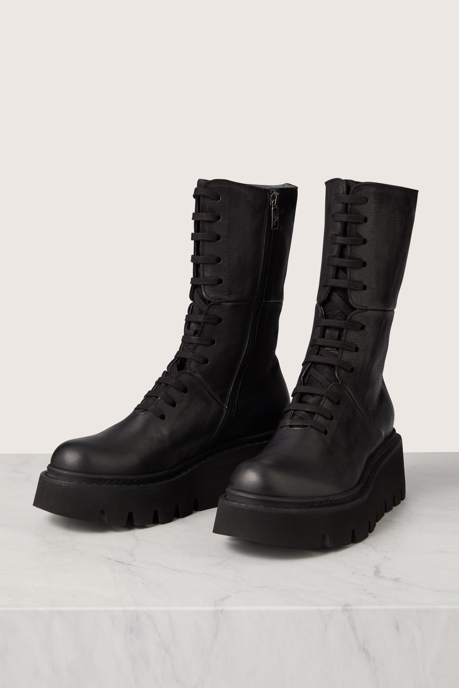 Italian craftsmanship meets Platform Lace Up Leather combat boots.