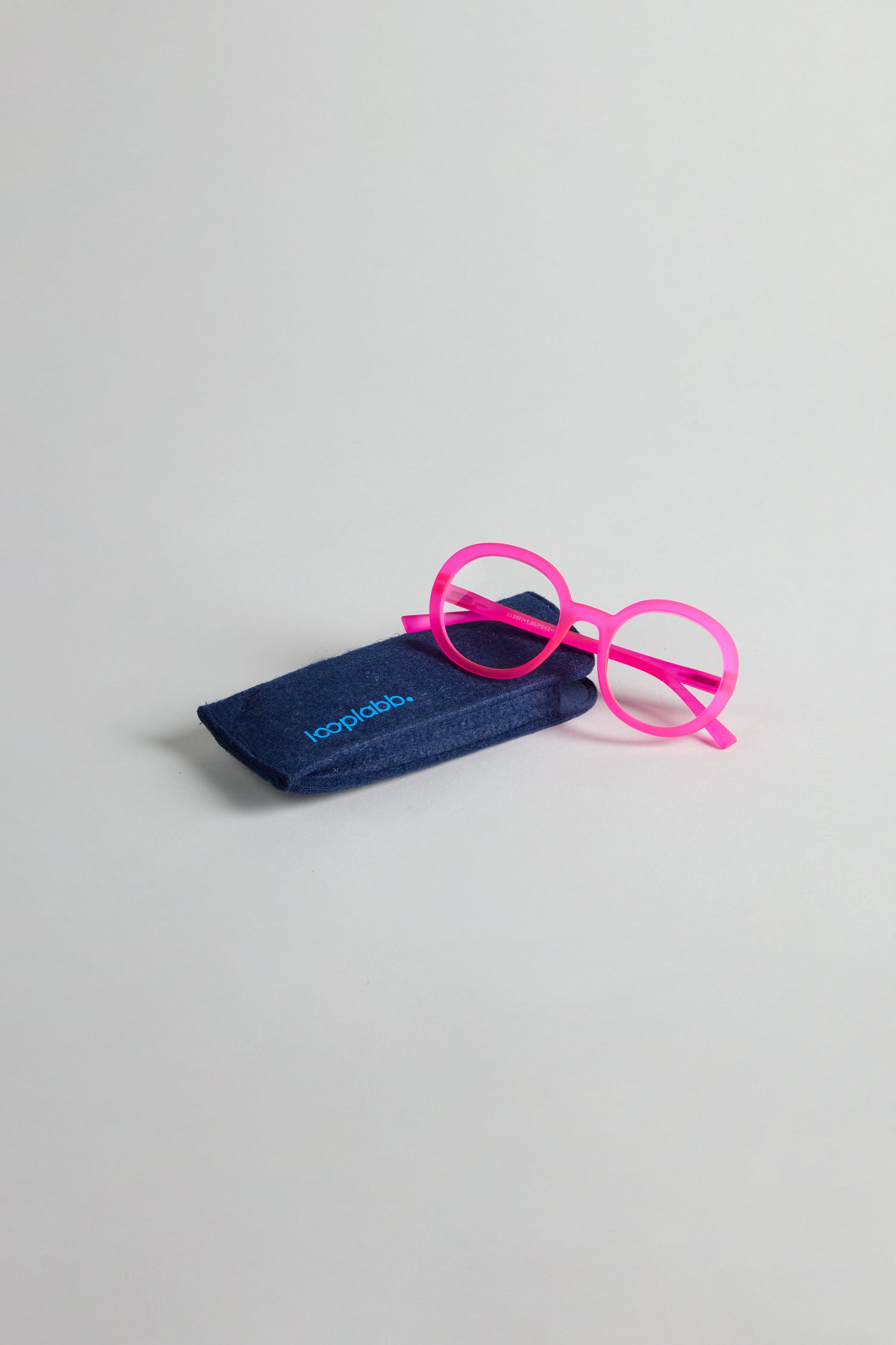 Neon Pink Round Reading Glasses shown beside a dark blue soft case on a plain light gray background.