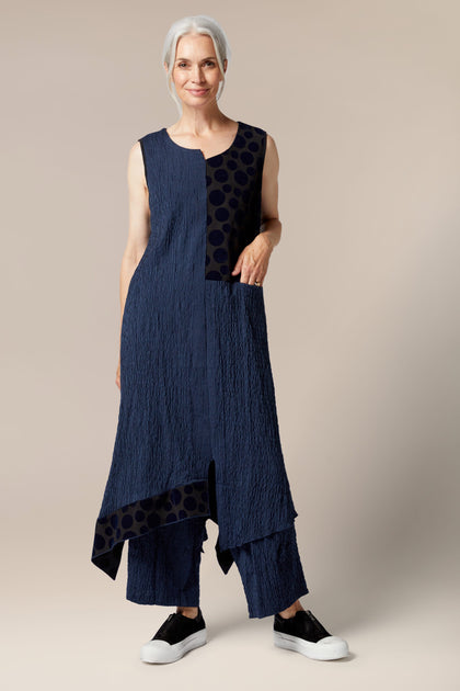A Luukaa clothing design featuring a woman wearing a Stripe Patch Dress, completed with a sleeveless style.