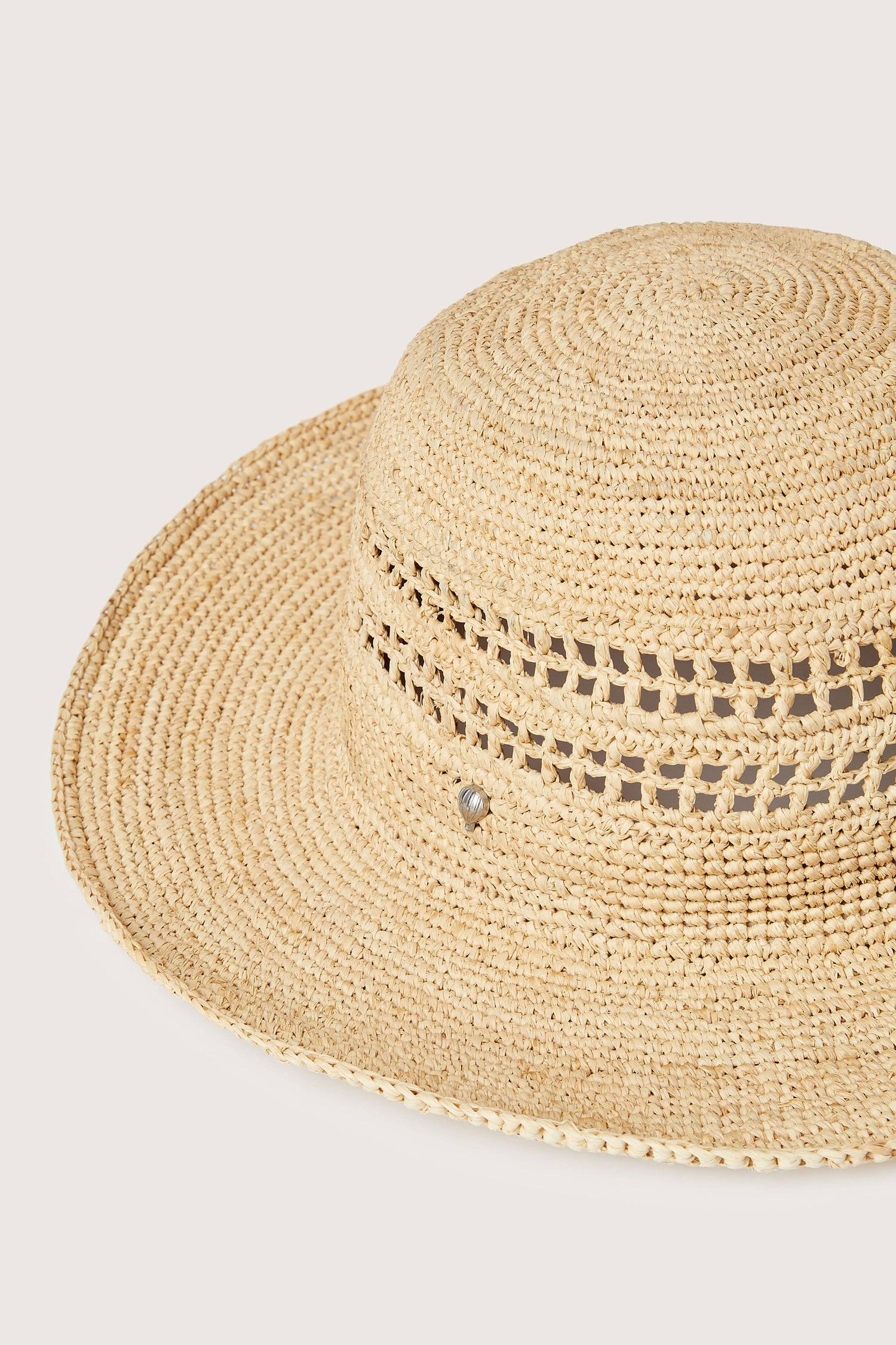 A Chapeau Westoloa in beige, perfect for your summer wardrobe, featuring a decorative band with open weave detail and a small metallic embellishment.