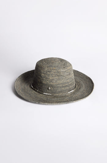 The Chapeau Westilux, a raffia-crafted hat featuring a wide brim and textured weave, rests elegantly on a plain white background—ideal for elevating your summer wardrobe.