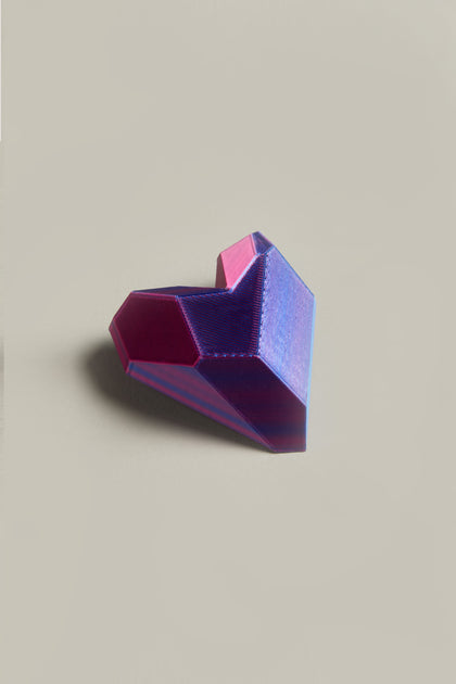 The 3D Printed Heart Brooch, featuring a geometric shape in purple and magenta hues, exemplifies modern accessory design against a plain background.