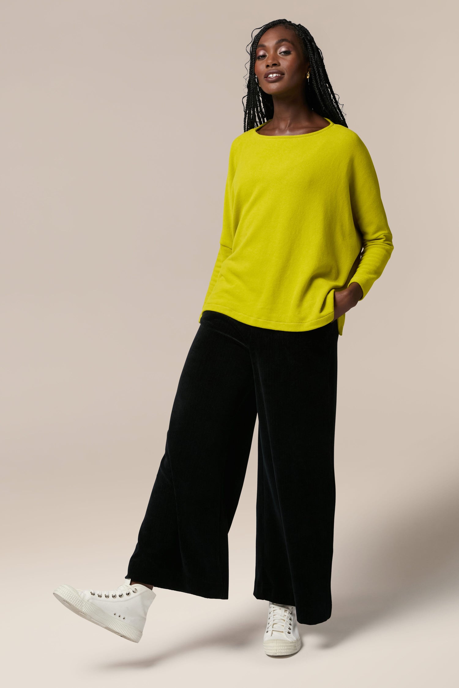 Mama B wearing yellow sweater and Bulbo Velvet Wide Leg Trouser.