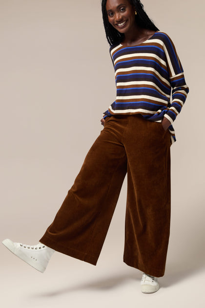 A woman wearing Bulbo Velvet Wide Leg Trousers and a striped tee made of cord fabric.