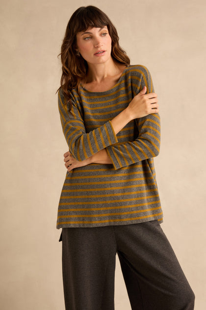 A woman wears a relaxed Scoop Neck Wide Stripe Jersey Top featuring wide gray and mustard-yellow horizontal stripes.