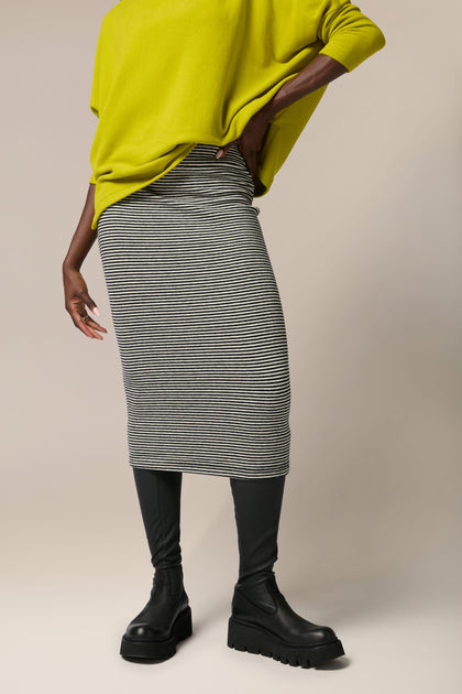 Mama B Lilla Skirt, A woman wearing a yellow sweater and grey skirt, soft touch woven fabric.