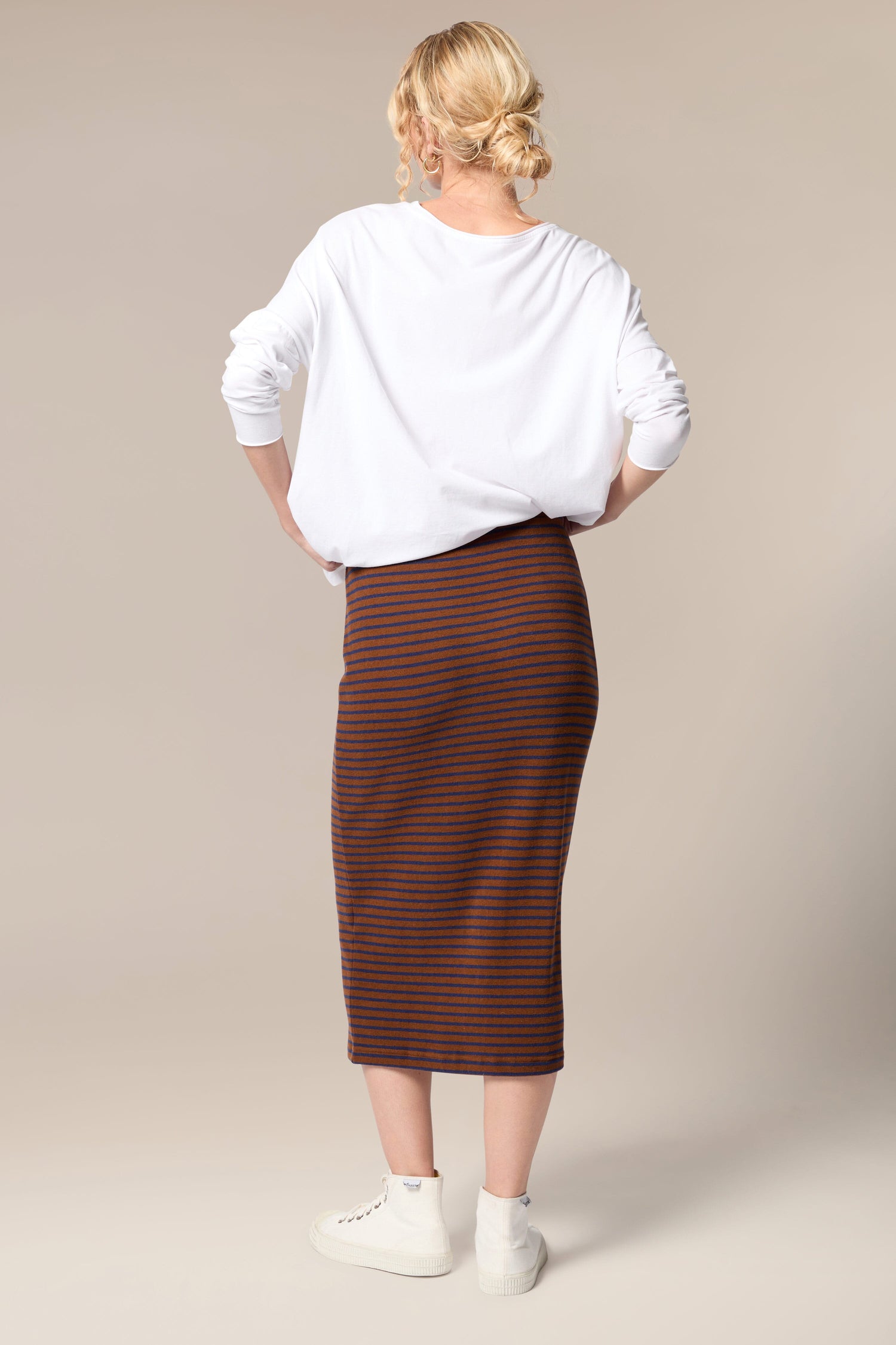 The back view of a woman wearing a Lilla Skirt, an all-occasion garment.