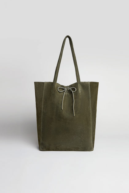 Khaki Soft Suede Tote Bag showcasing a minimalist design with long handles and a bow tie closure, photographed against a plain light background. The spacious interior is ideal for carrying your everyday essentials.