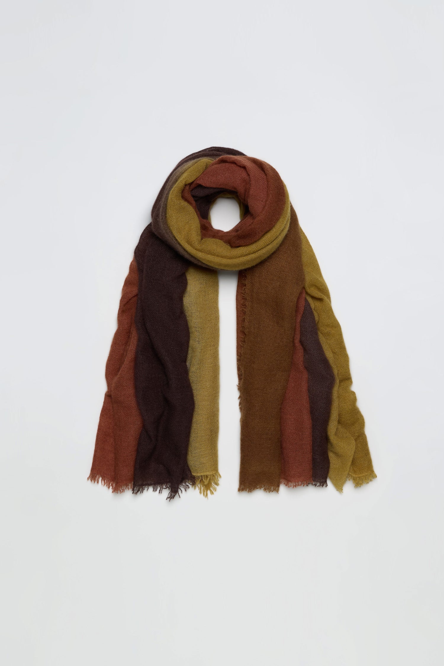 The Rust and Ochre Soft Colourblend Cashmere Shawl features vertical stripes in rich brown, mustard yellow, and rust tones, showcased against a plain white background. This luxurious cashmere shawl embodies the warmth of autumn with its soft texture and timeless design.
