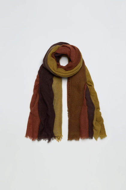 The Rust and Ochre Soft Colourblend Cashmere Shawl features vertical stripes in rich brown, mustard yellow, and rust tones, showcased against a plain white background. This luxurious cashmere shawl embodies the warmth of autumn with its soft texture and timeless design.