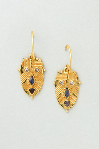 Gold Plated Labradorite Mini Faces Earrings, featuring stylized face designs with geometric patterns and sparkling gemstones, stand out against a light gray background. These unique MJU10516GB2 earrings make a bold statement.