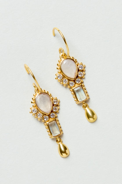 The Gold Plated White Moonstone Ariel Earrings feature teardrop and rectangular gemstones with small clear stones and gold teardrop charms.