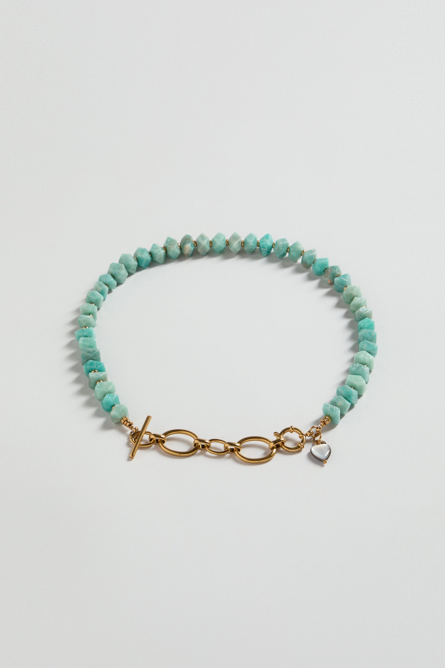 The Amazonite Bead Necklace features turquoise and amazonite gemstone beads with a gold toggle clasp, shown on a plain white background.