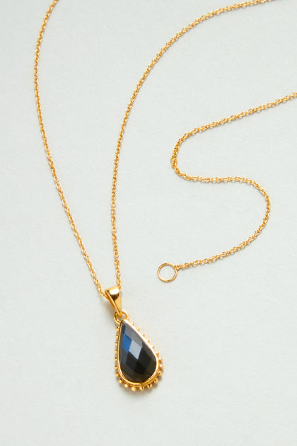 The Gold Plated Labradorite Teardrop Necklace, style MJU3726GB2, features a teardrop-shaped labradorite pendant on a gold chain.