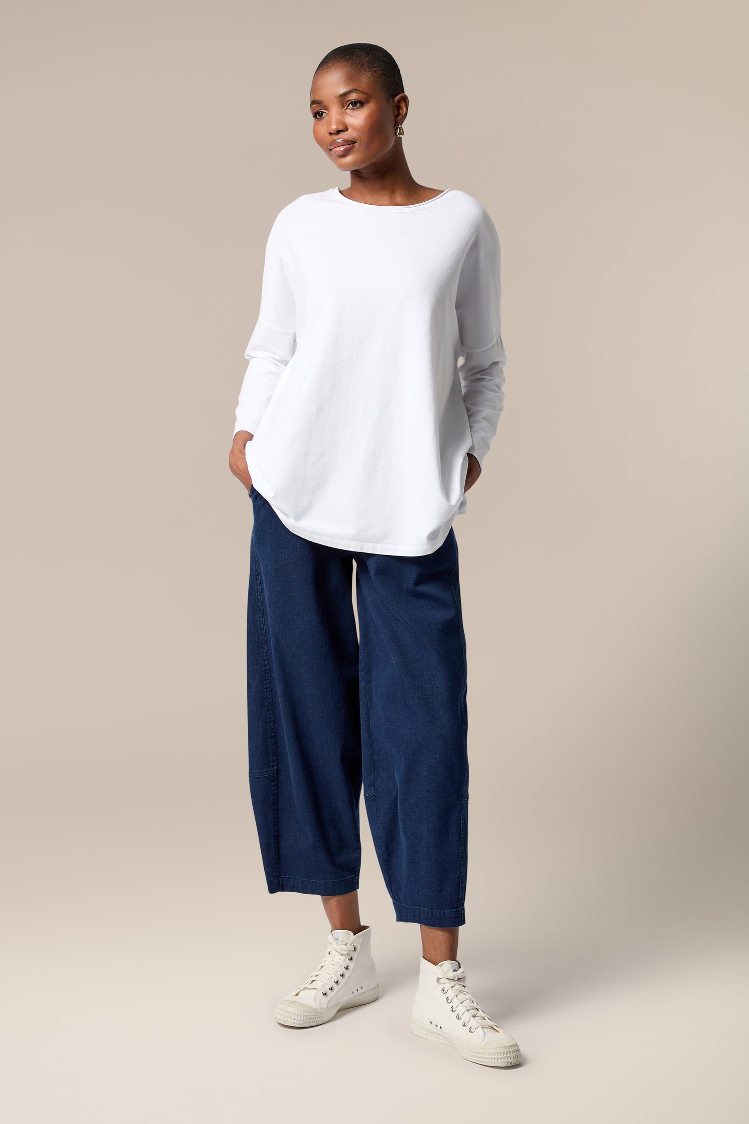 A woman wearing Stretch Denim Bubble Trousers with an elasticated waist.