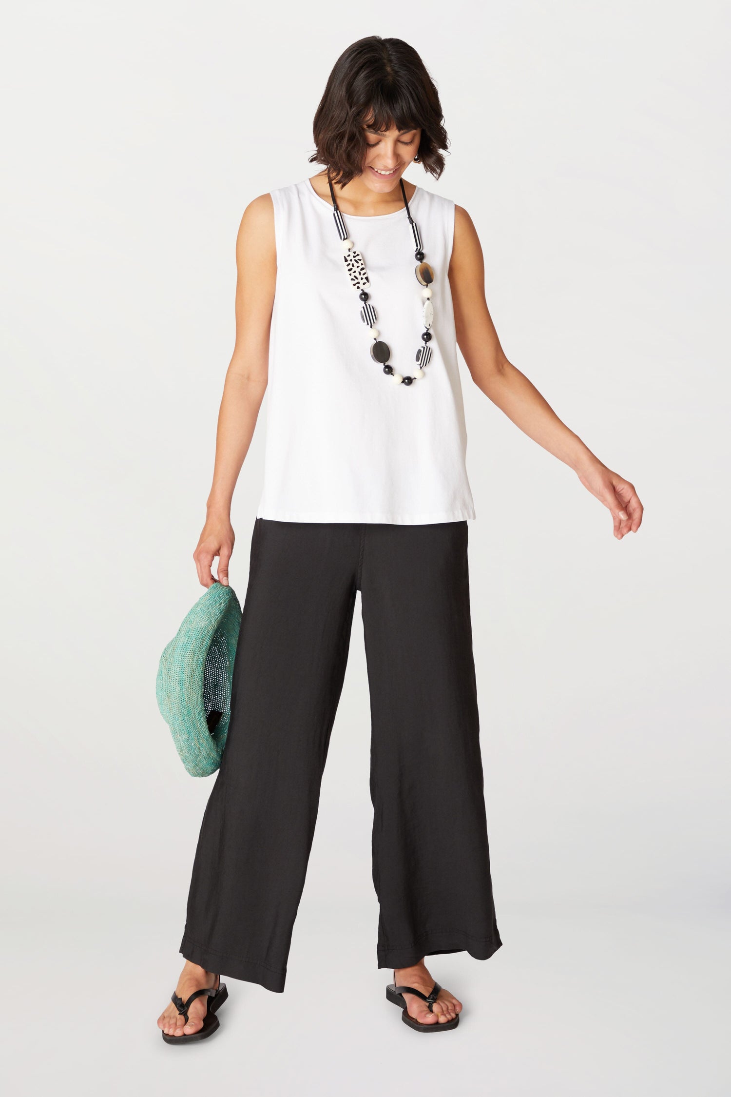 A woman wearing Soft Tencel Wide Trousers made of TENCEL LYOCELL fabric with an elasticated waistband.