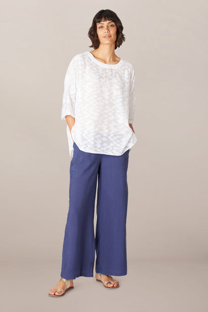 A woman wearing the Soft Tencel Wide Trouser in TENCEL LYOCELL fabric.