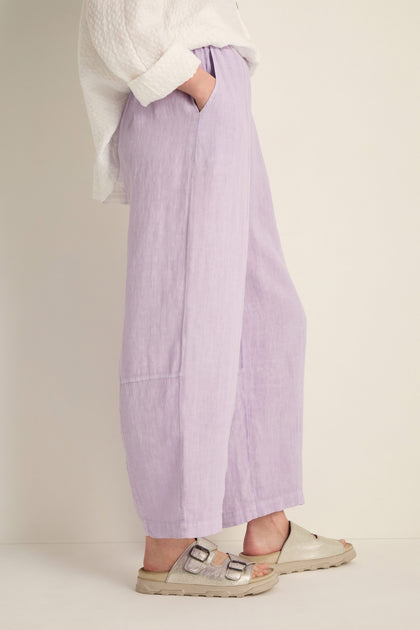 Model wears Linen Seam Detail Lilac Bubble Trousers featuring an elasticated waist, styled with a white textured top and silver sandals, standing against a light plain background.