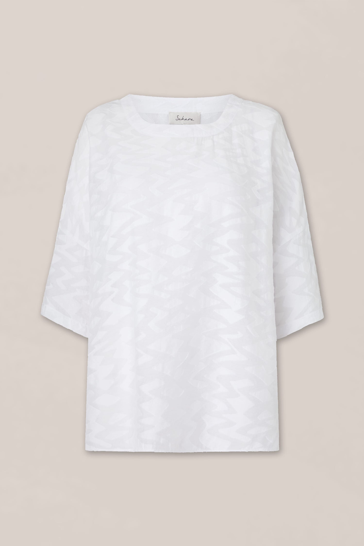 A white Zig Zag Jacquard Top with a Zig Zag Jacquard pattern on it.