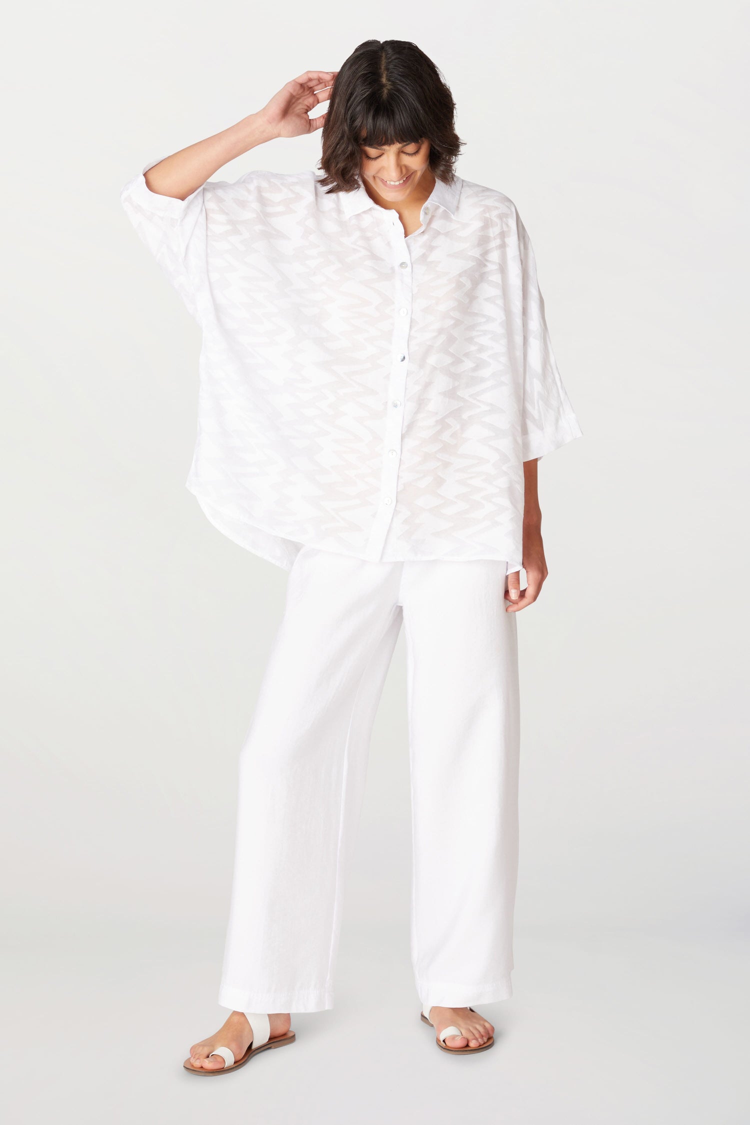 A woman wearing a Zig Zag Jacquard Shirt made of a viscose blend.