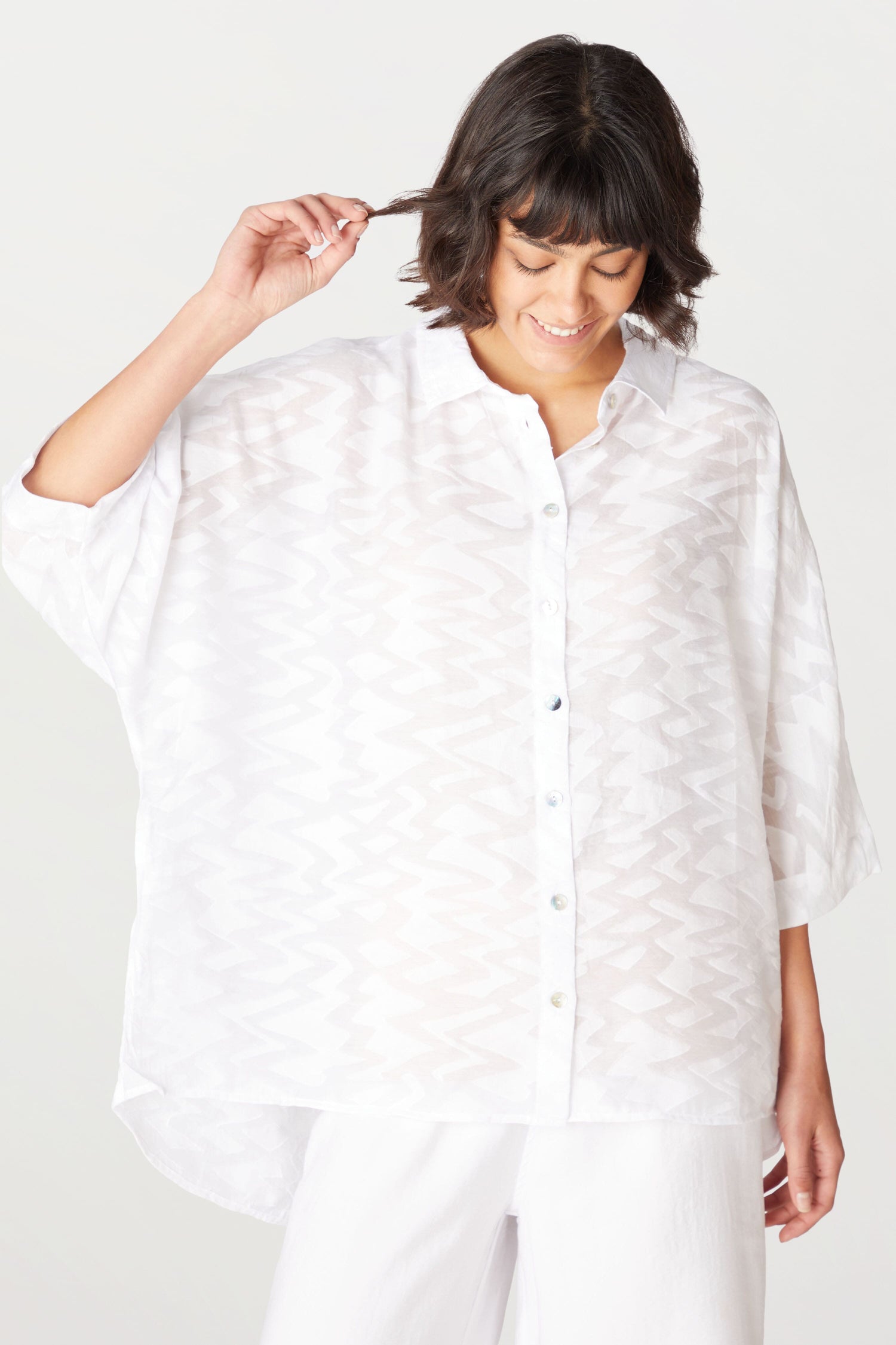 A woman wearing a Zig Zag Jacquard Shirt.