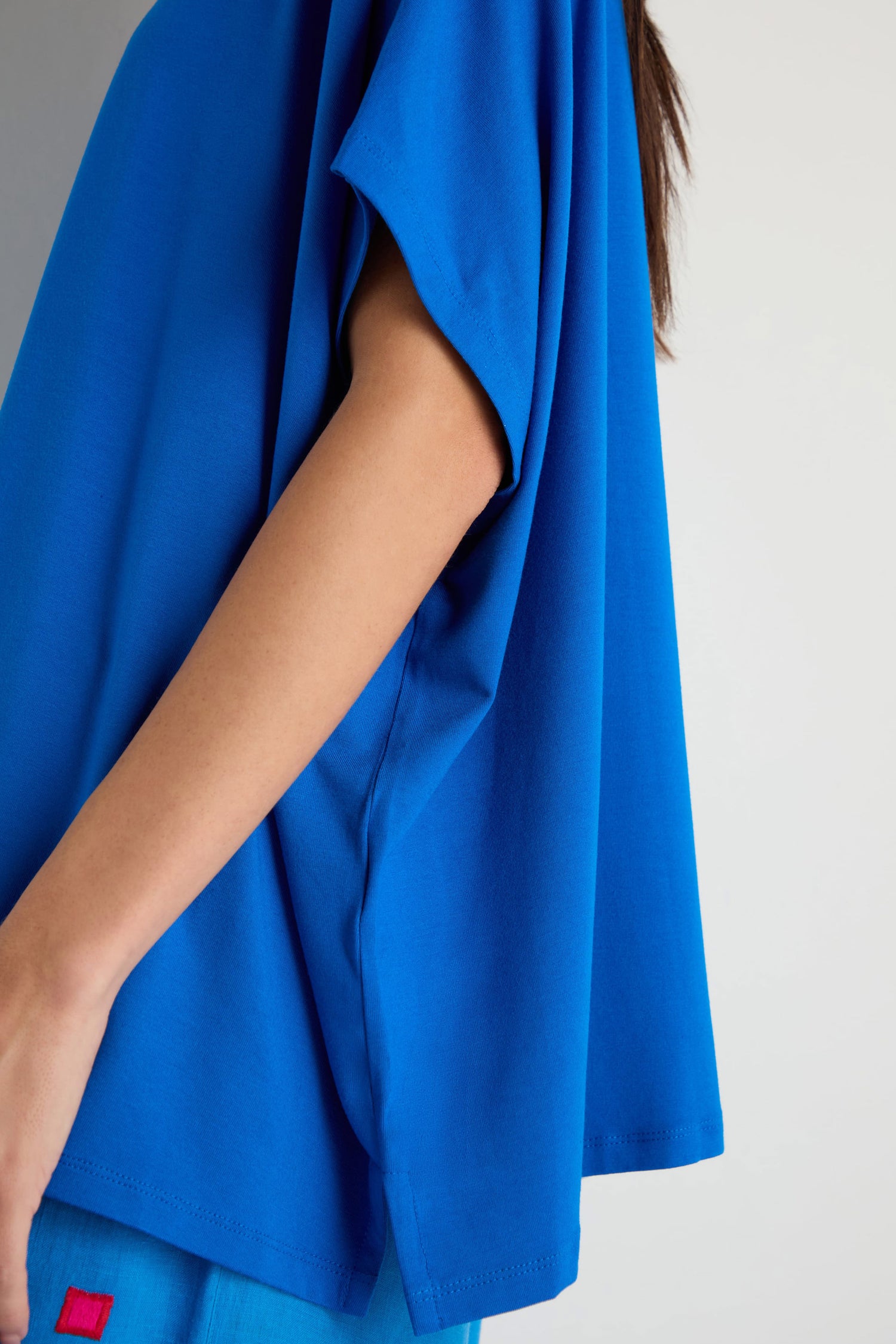 Model wearing the Viscose Jersey Boxy Top in bright blue with matching blue pants, shown from shoulder to thigh against a plain background.