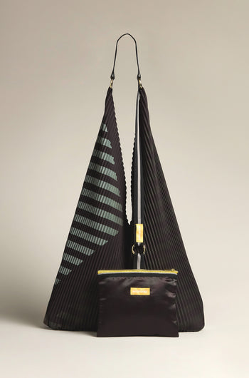 The Pleated Y Handbag features a black design with geometric patterns, crafted sustainably, and includes a front zippered pouch on a neutral backdrop.