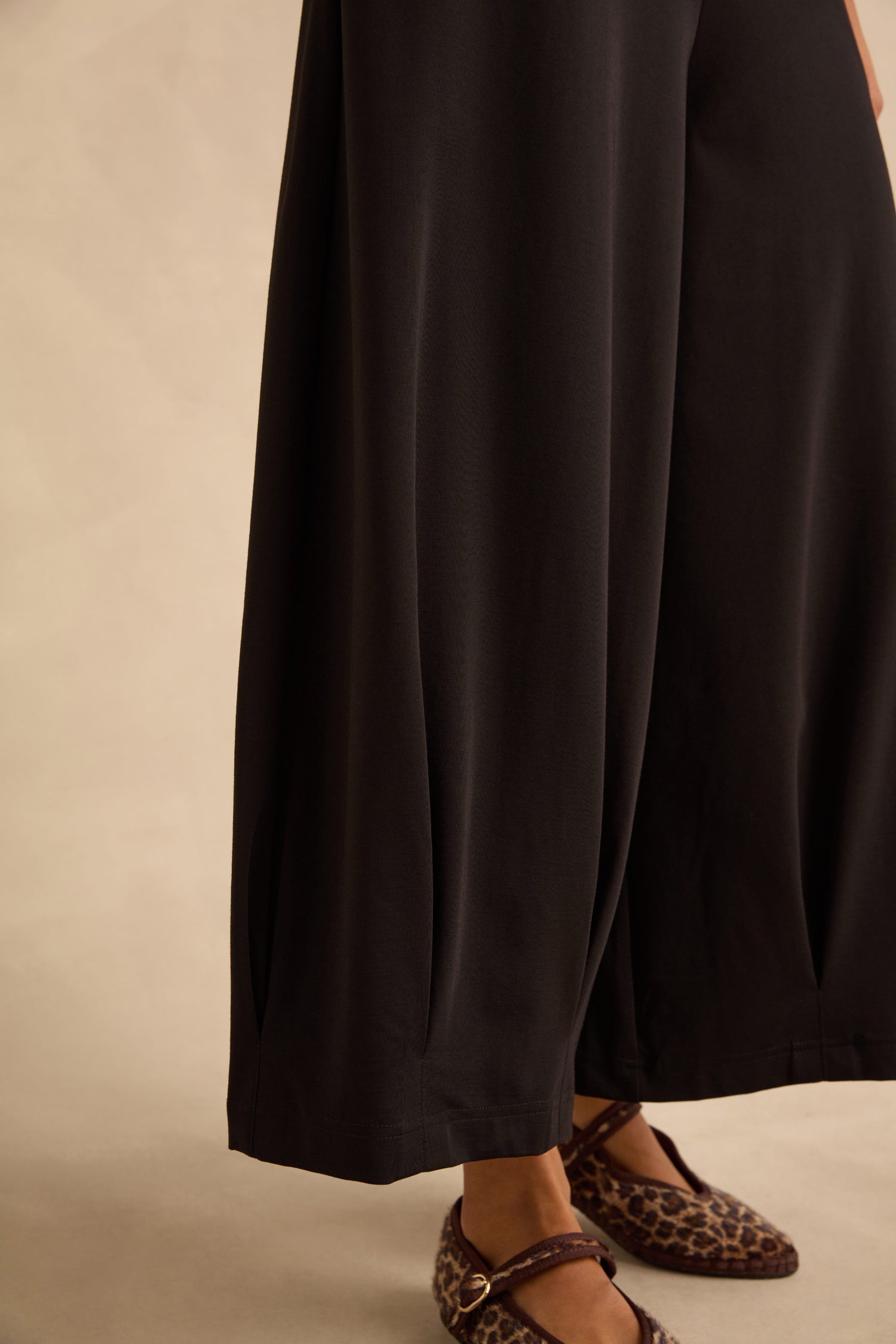 Black Pleated Hem Wide Jersey Trousers worn with leopard-print buckled flats.
