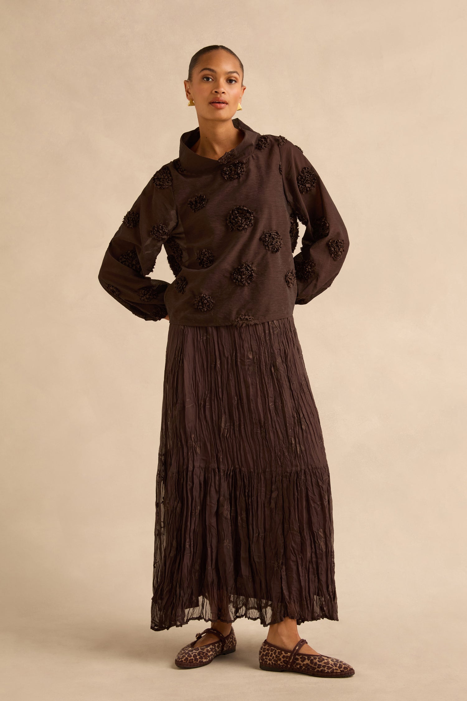 A model wears an Applique Flowers Sheer Boxy Top with floral appliqués and a matching long tiered skirt, paired with leopard-print ballet flats.