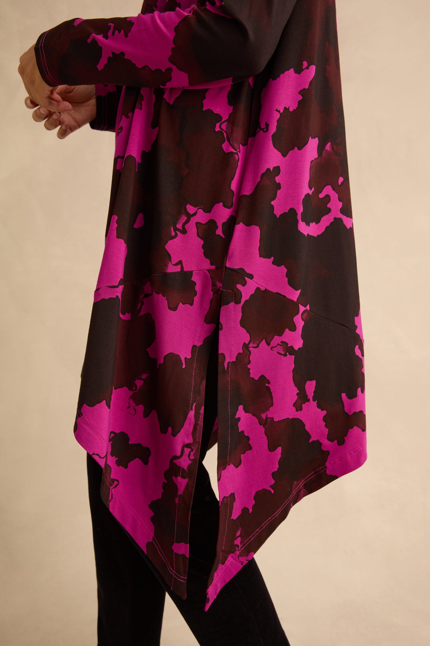 The Autumn Leaves Tunic is a long-sleeved stretch jersey tunic featuring a fuchsia and dark brown abstract botanical print with side slits.