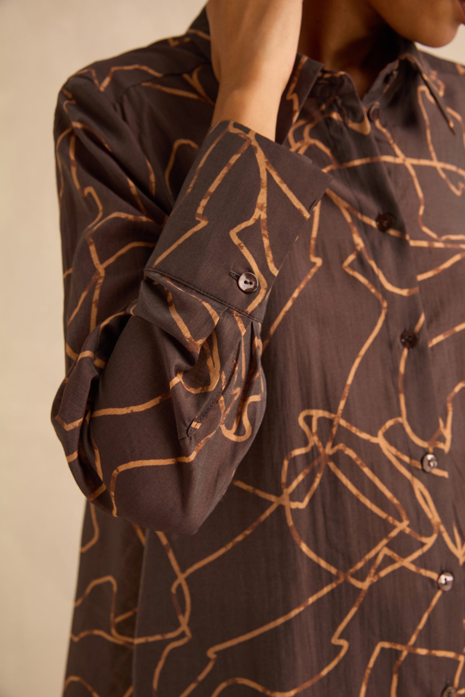 Swirl Print Sheer Shirt in brown with a tan, abstract swirl print and gold line detailing.