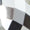 Close-up of a geometric pattern in black, white, and gray rectangles, echoing the bold design of the Silver Disco Necklace.