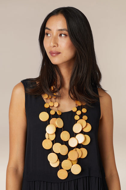 Woman with long hair wearing a black sleeveless top and a Waterfall Spheres Necklace.