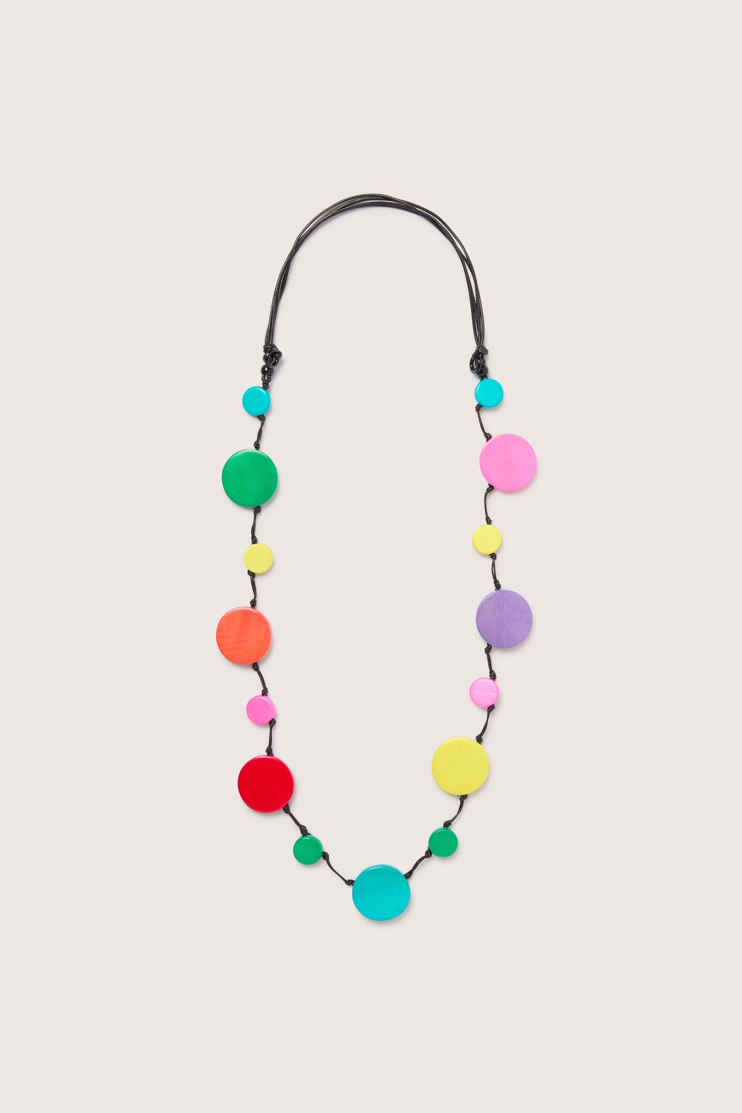 Rainbow Planets Necklace with colorful wooden discs on a white background.