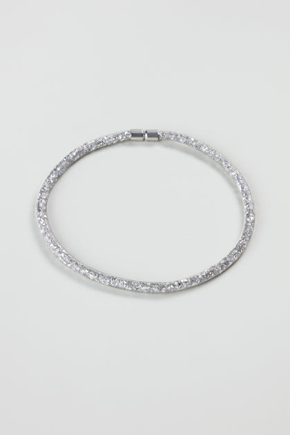 The Short Silver Diamante Necklace features a sleek design with sparkling details, reflecting modern jewellery trends and displayed on a plain white background.
