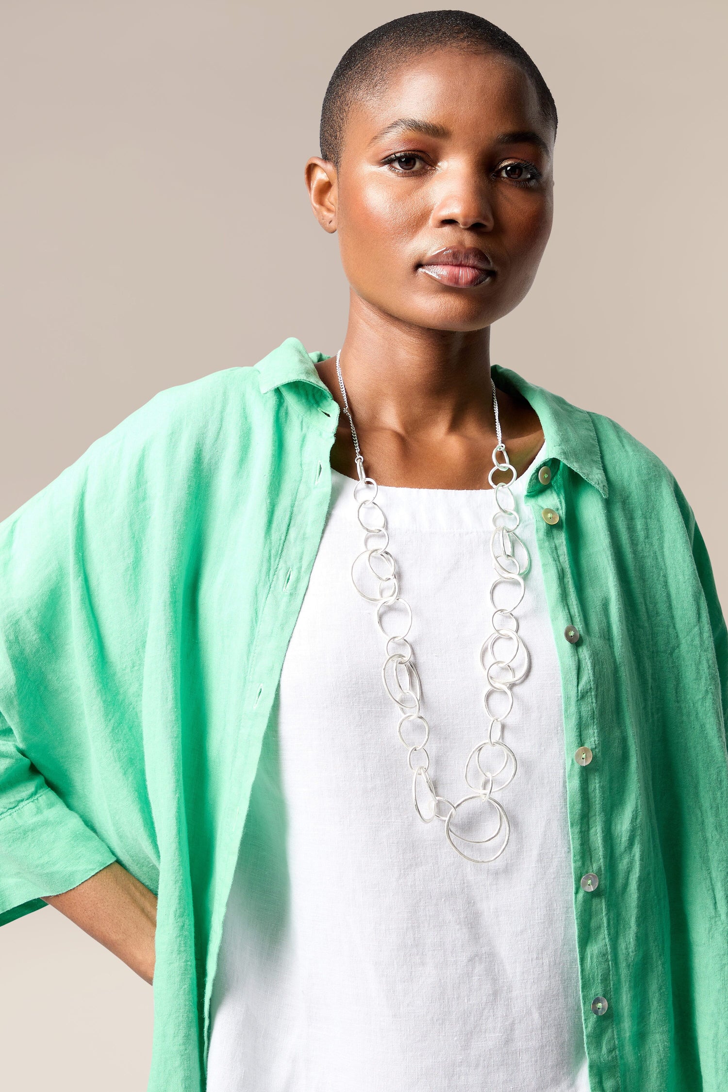 A woman wearing a Silver Hoops Necklace.