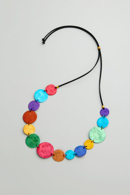 The Colourful Aluminium Discs Necklace features multicolored flat circular aluminium beads on a black cord in a graduated, layered design.
