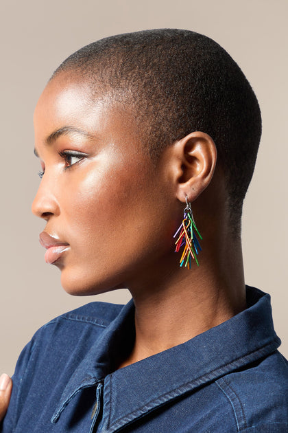 A black woman wearing colorful Fringe Earrings made of aluminium.