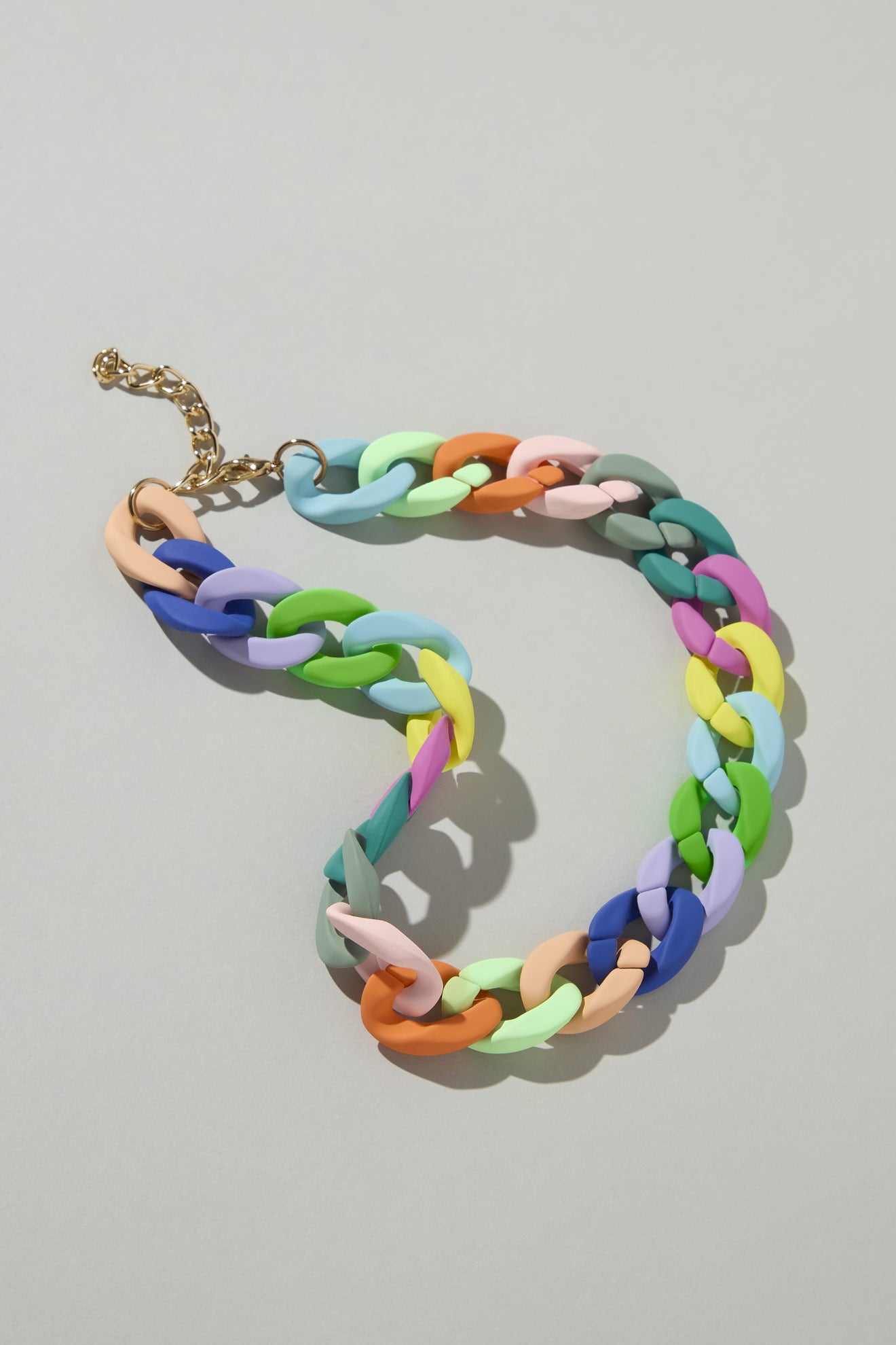 The Colour Pop Link Necklace is a statement piece featuring chunky links in pastel shades of pink, blue, green, and orange. Finished with a gold clasp, this bold accessory adds the perfect color pop to any outfit.