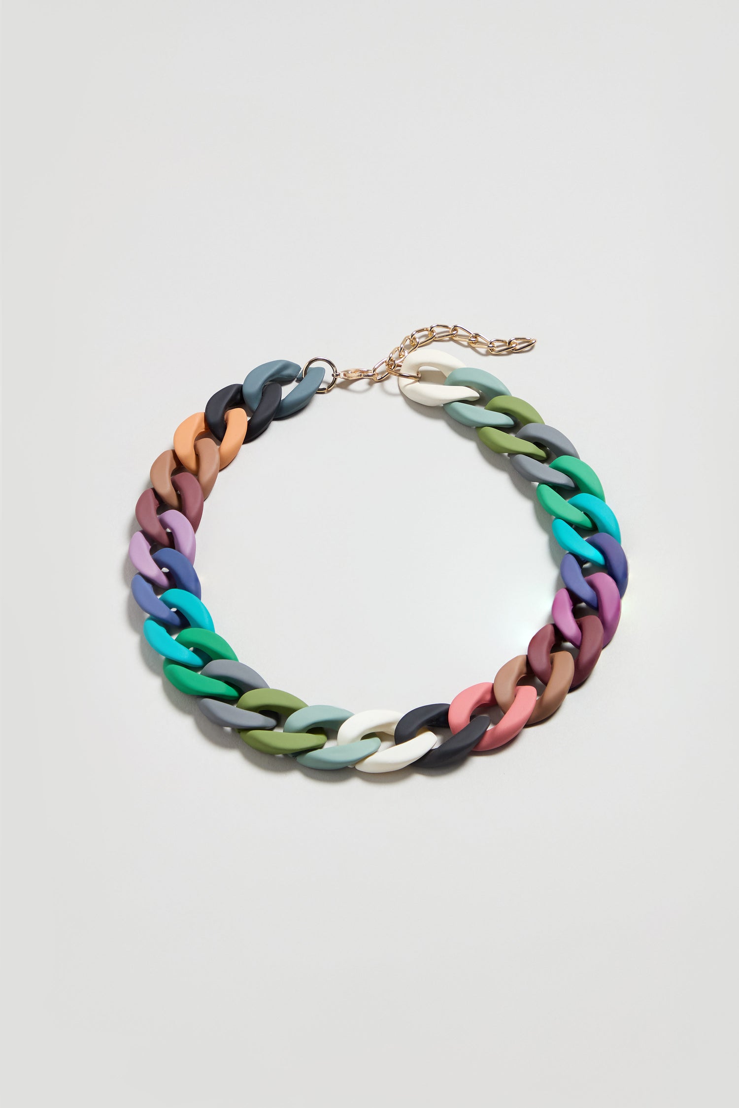 The Colour Pop Link Necklace features vibrant, chunky interlocking links and a gold adjustable clasp—a bold statement piece perfect for adding color to any outfit. Shown on a simple light background.