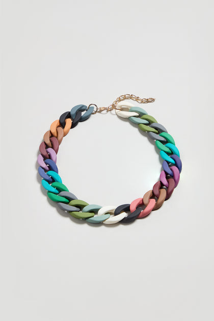 The Colour Pop Link Necklace features vibrant, chunky interlocking links and a gold adjustable clasp—a bold statement piece perfect for adding color to any outfit. Shown on a simple light background.