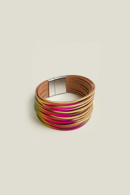 The Woven Metallic Bracelet is a colorful multi-strand twisted leatherette accessory with a magnetic clasp, featuring shades of beige, pink, and yellow against a plain background.