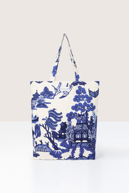 A Willow Canvas Bag with blue floral and Asian-inspired landscape print against a neutral background, suitable as a reusable shopping bag.