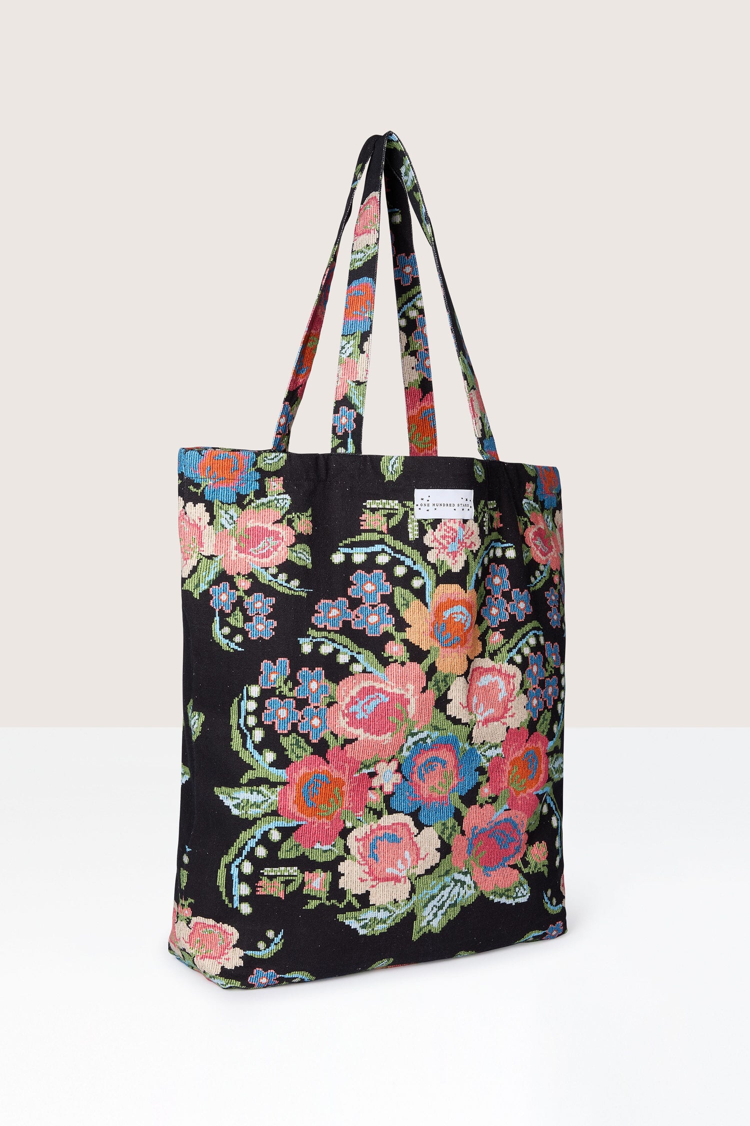 A sustainable Woven Flower Canvas Bag with a eco-friendly floral print.